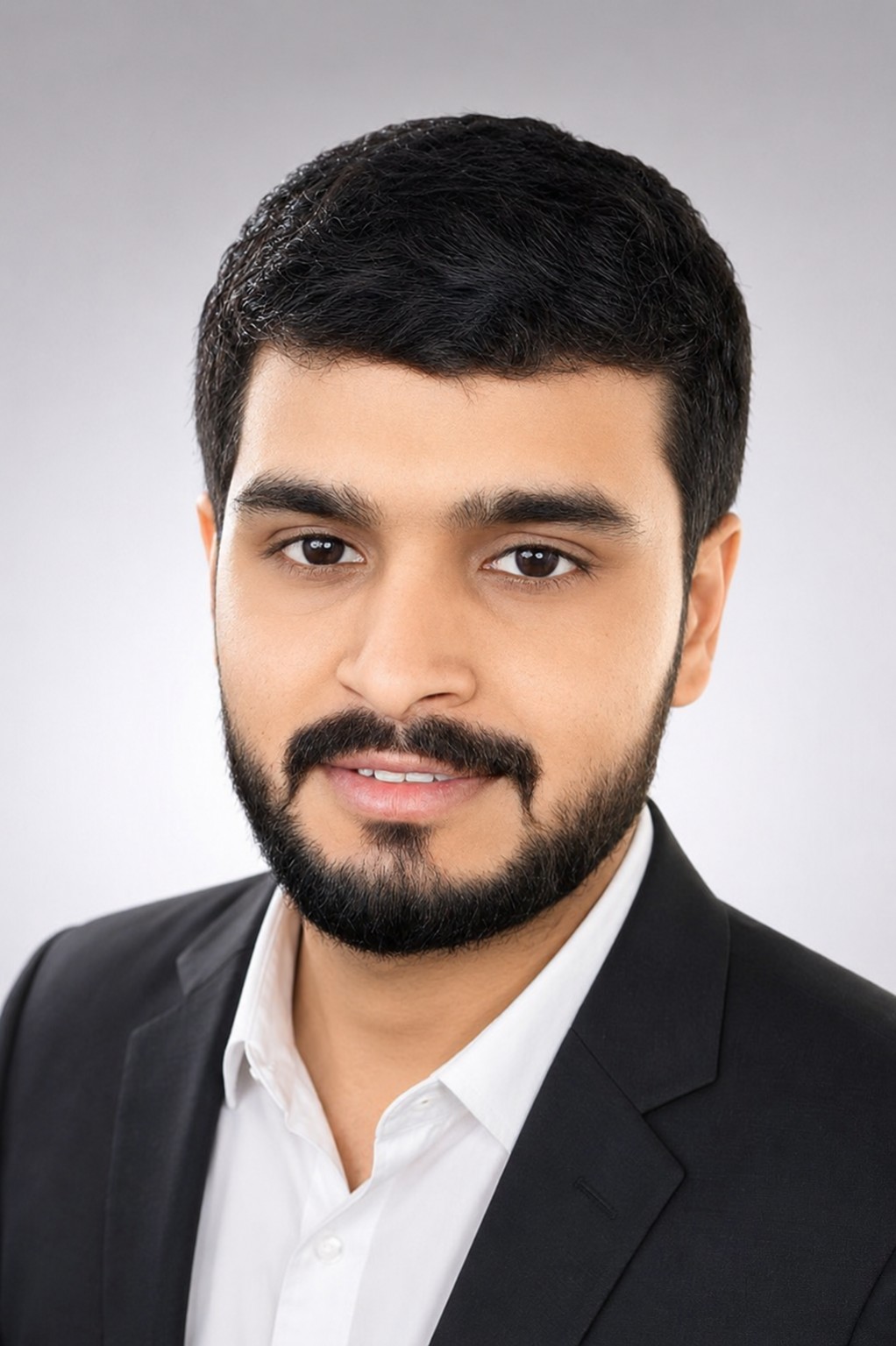 Tejas Dhikale wearing a black blazer and white shirt